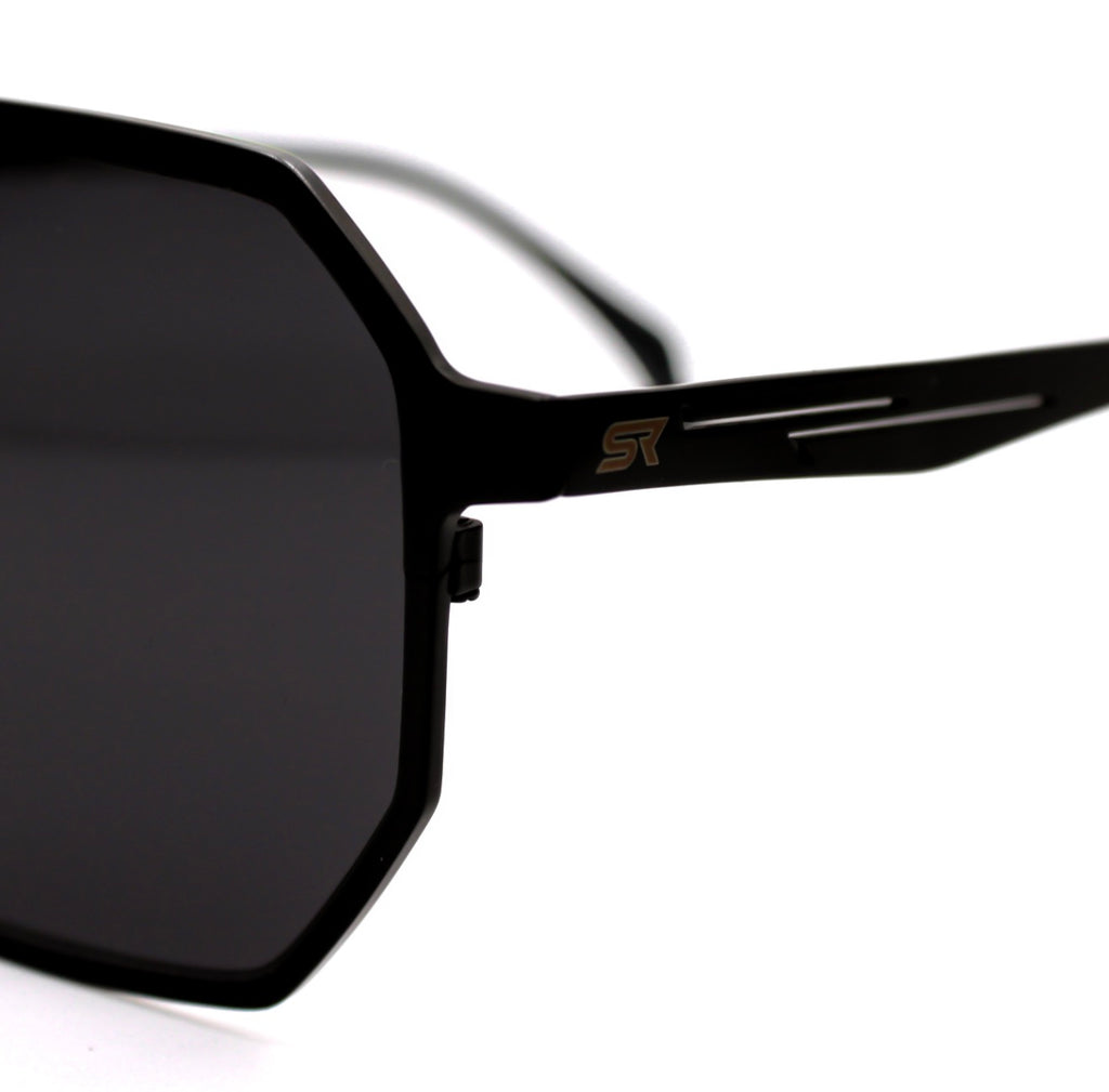 Close-up of SkyRift Vector sunglasses showing pure titanium black frame and engraved SR logo